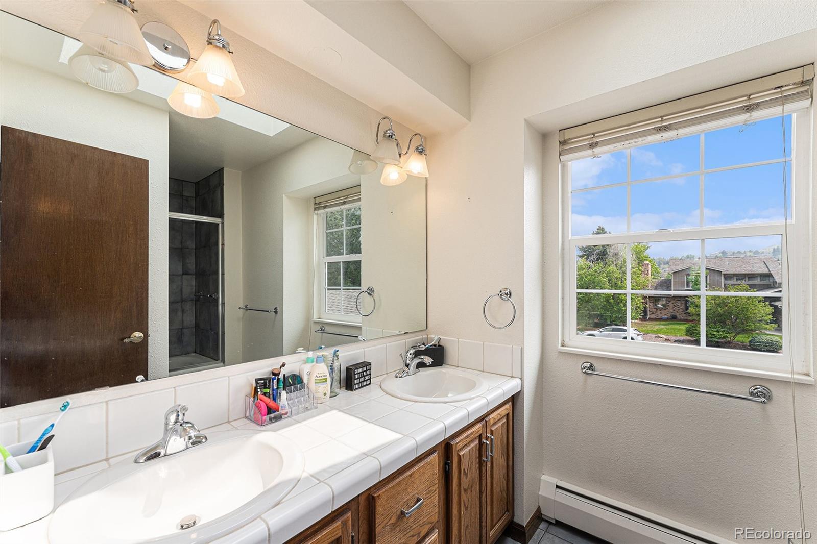 217 South Deframe Way Golden, CO 80401 - Photo 22 of 34 a bathroom with a sink vanity and a mirror