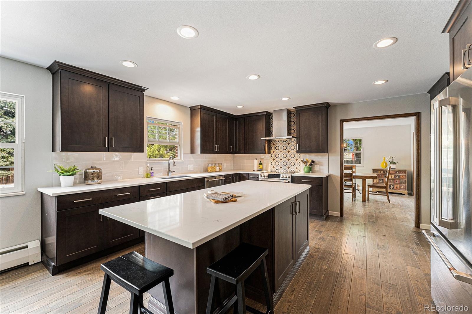 217 South Deframe Way Golden, CO 80401 - Photo 7 of 34 a kitchen with a sink a center island cabinets and appliances