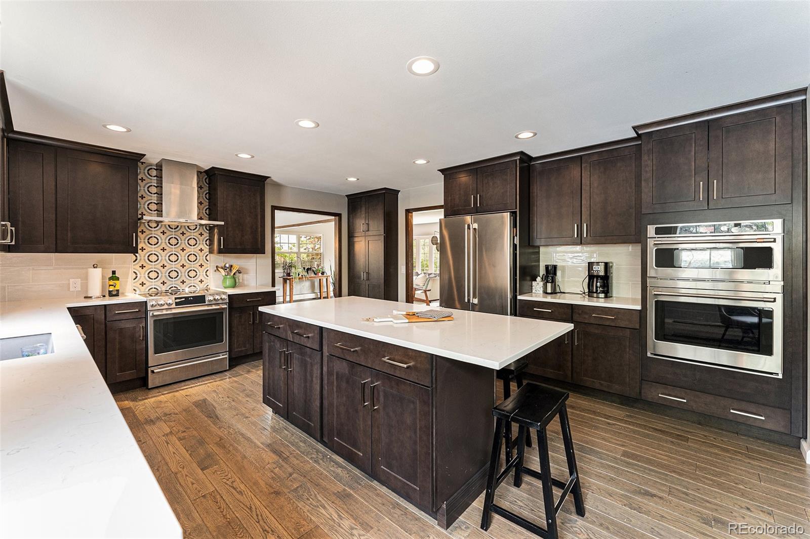 217 South Deframe Way Golden, CO 80401 - Photo 8 of 34 a kitchen with stainless steel appliances kitchen island granite countertop a stove refrigerator and cabinets