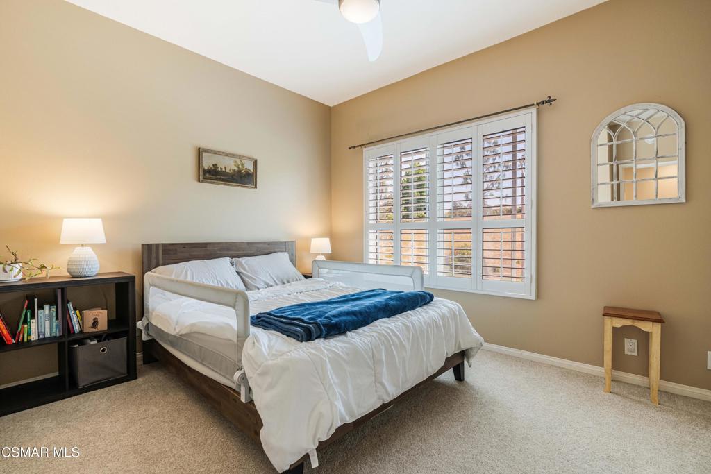 11529 Treeview Court Moorpark, CA 93021 - Photo 17 of 23 a bedroom with a bed lamp and a window