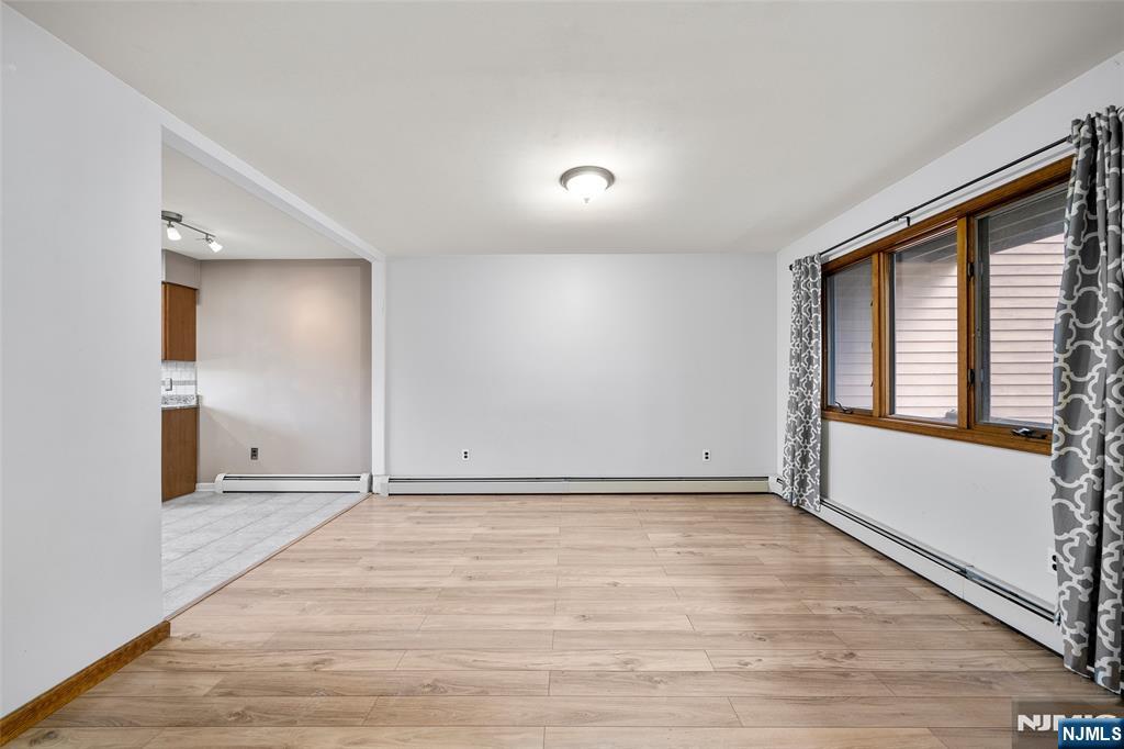 140 Allwood Road, Unit C Clifton, NJ 07012 - Photo 11 of 31 a view of an empty room with wooden floor and a window