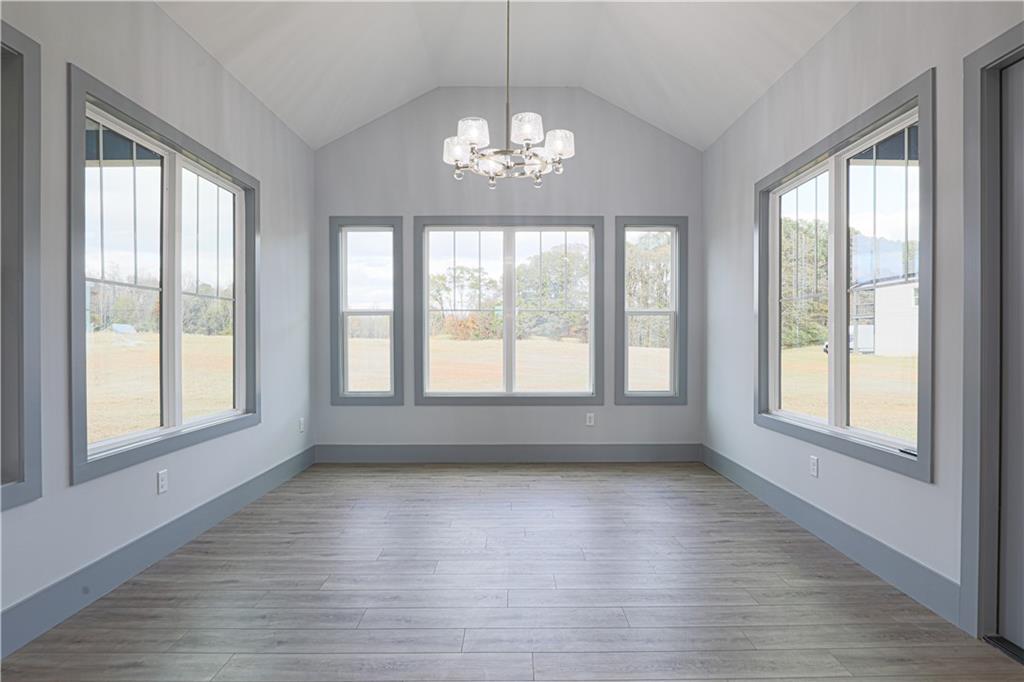 1341 Wheeler Creek Road Maysville, GA 30558 - Photo 17 of 51 a view of an empty room with wooden floor and a window