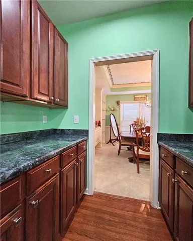 a view of kitchen with granite countertop window and a sink