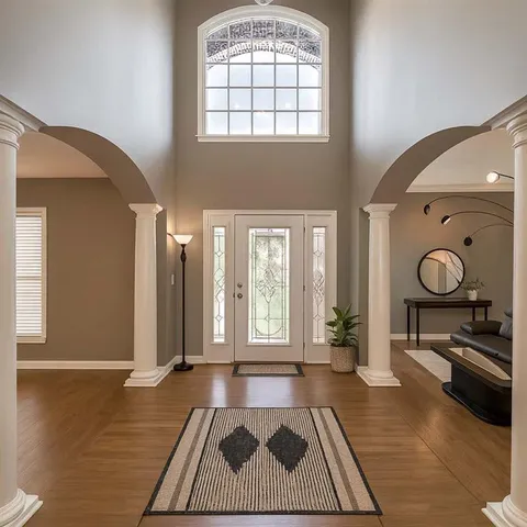 a living room with a rug and a window
