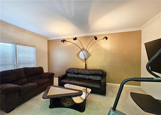 a living room with furniture a couch and a flat screen tv