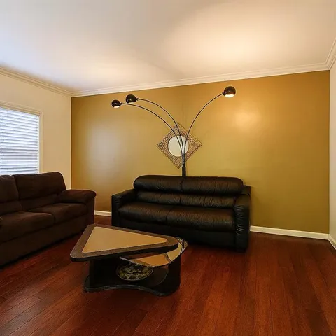a living room with a couch and wooden floor