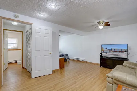 a living room with furniture and a wooden floor