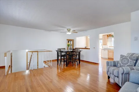 a view of a dining room with furniture and wooden floor