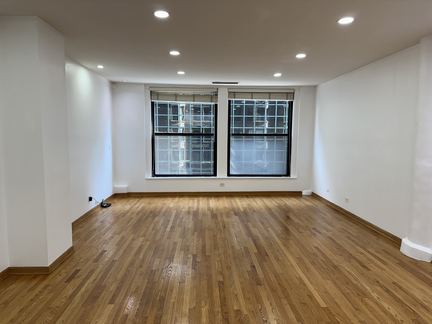 431 South Dearborn Street, Unit 507 Chicago, IL 60605 - Photo 2 of 25 a view of an empty room with wooden floor and windows