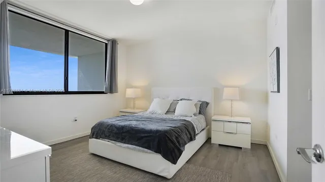 a bedroom with a bed and a night stand