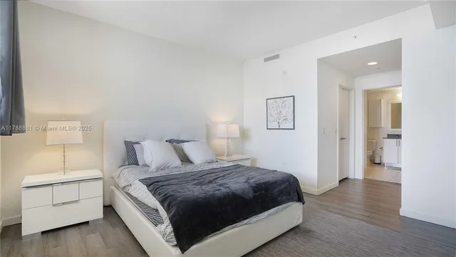 a bedroom with a bed and a night stand