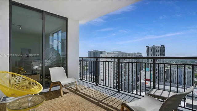 a view of a balcony with chair and table