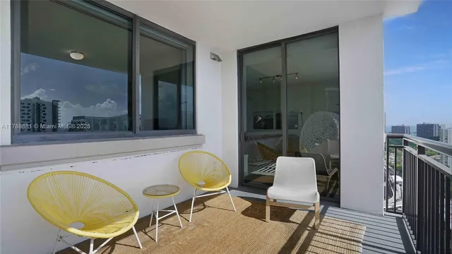 a view of a dining room with furniture and a rug