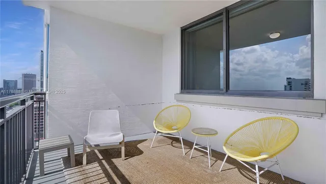 a bathroom with a sink mirror and a chair