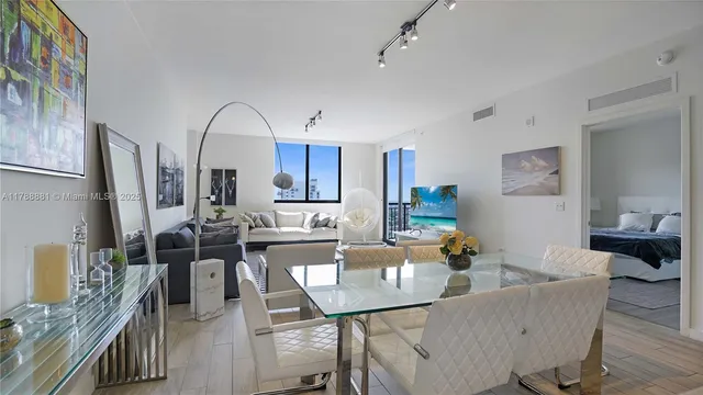 a living room with lots of furniture and a chandelier