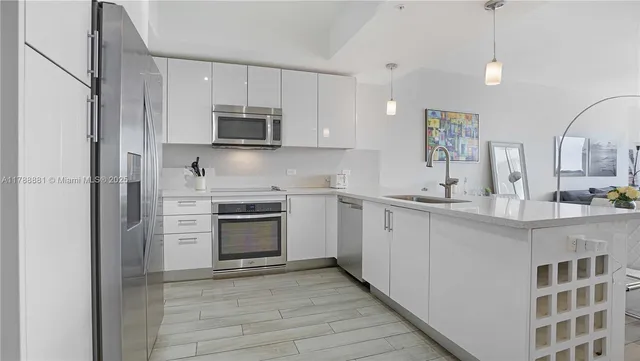 a kitchen with stainless steel appliances granite countertop a stove and a sink