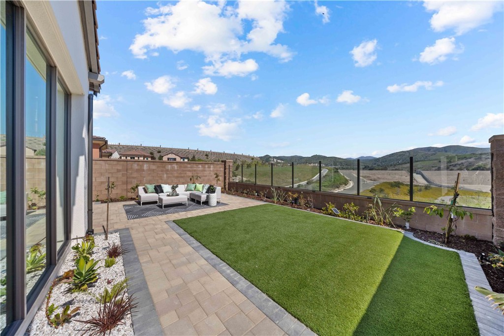 a view of a backyard with sitting area