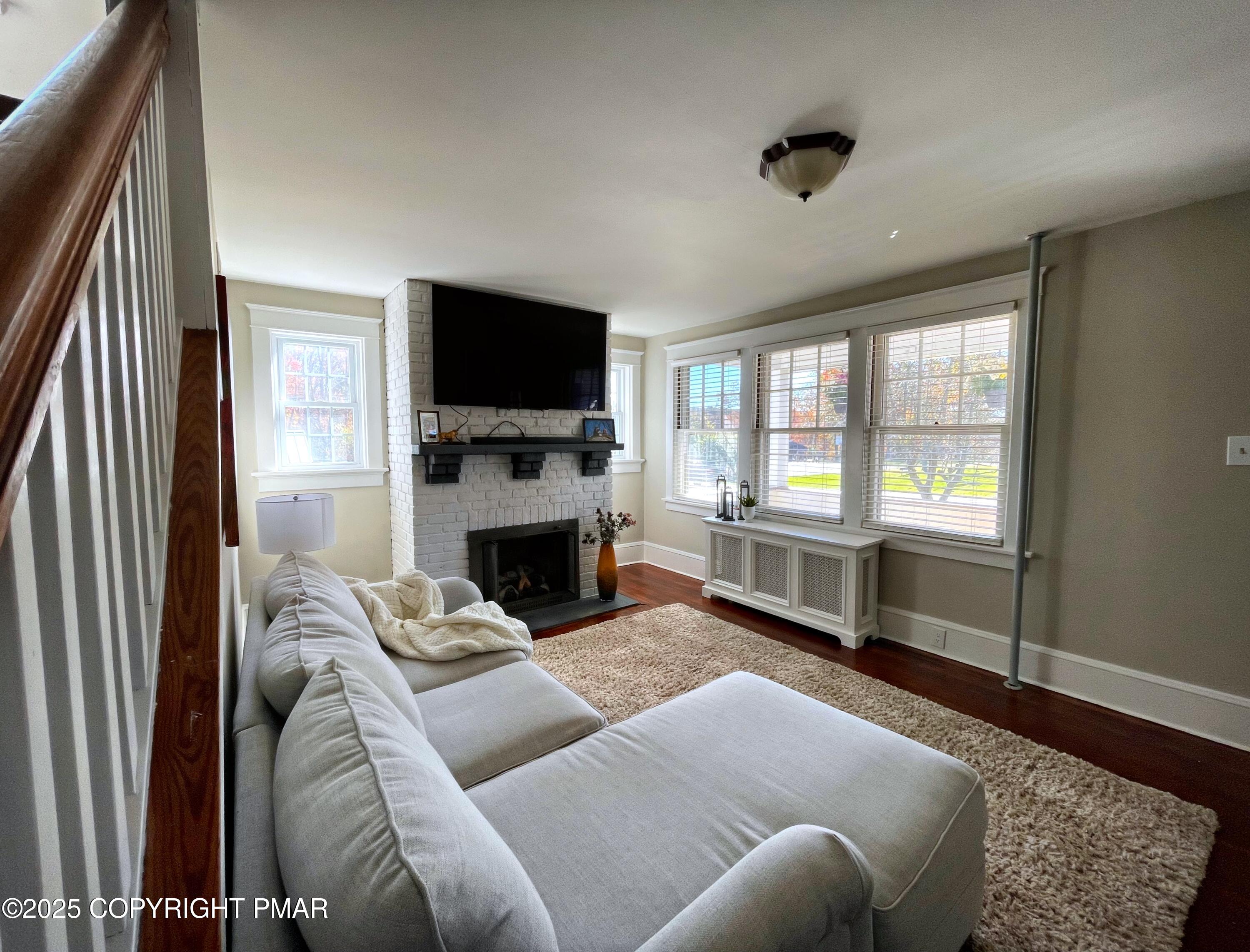 3035 Church Road Mountain Top, PA 18707 - Photo 4 of 27 a living room with furniture a flat screen tv and a fireplace