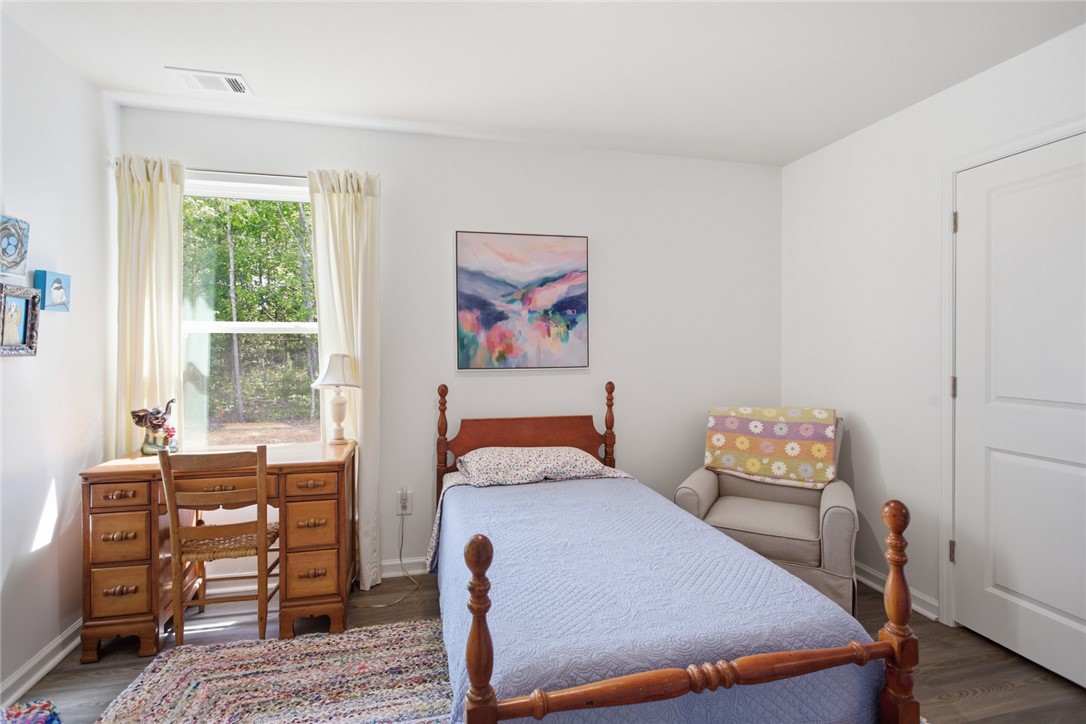 412 Chadwick Lane Walhalla, SC 29691 - Photo 13 of 37 This serene bedroom offers a private woodland view through its large window, creating a peaceful retreat.