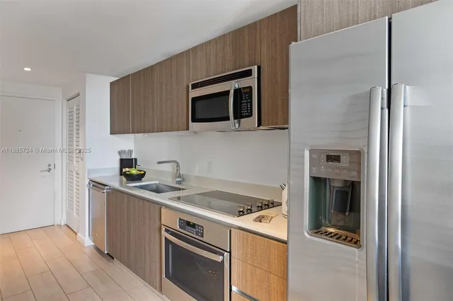 a kitchen with stainless steel appliances granite countertop a stove and a refrigerator