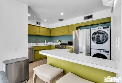 a kitchen with a refrigerator and a stove
