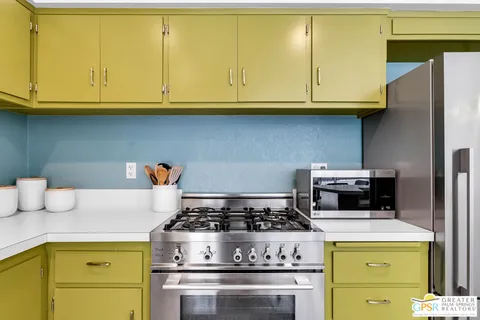 a stove top oven sitting inside of a kitchen