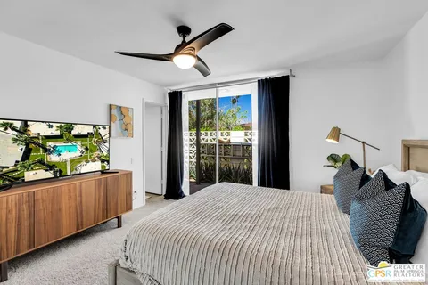 a bedroom with a bed and a large window
