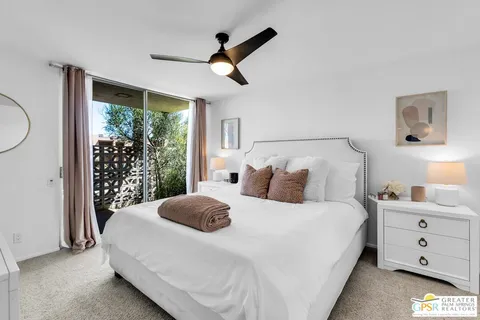 a bedroom with a large bed and a large window