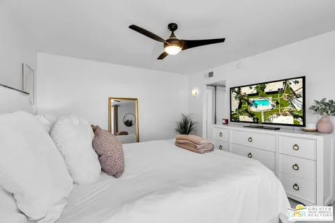 a bedroom with a bed and a flat screen tv