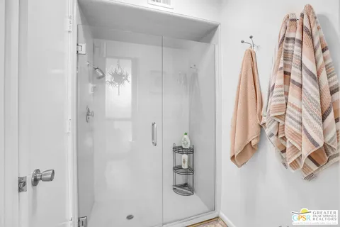 a bathroom with a shower and a sink