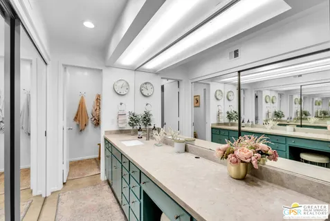 a bathroom with a sink mirror and vanity