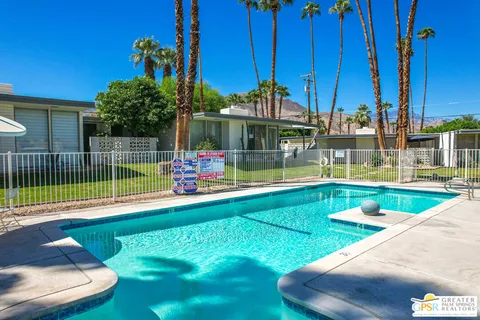 a view of a backyard with swimming pool