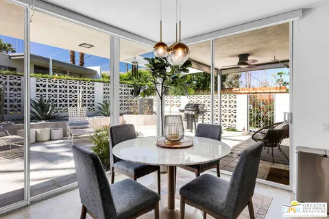 a dining room with furniture and window