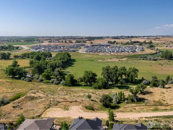 an aerial view of a house with a yard and lake view