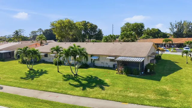 a aerial view of a house with swimming pool and a yard