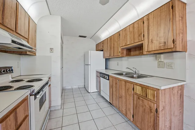 a kitchen with a sink a stove and refrigerator