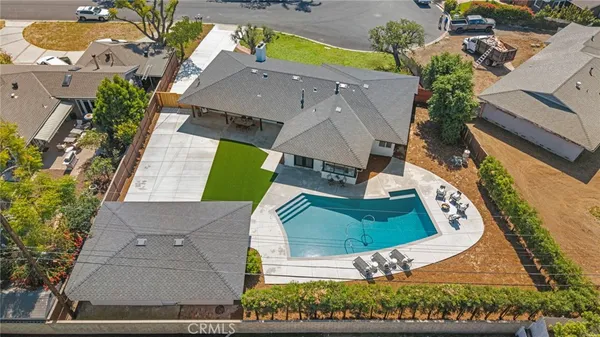 an aerial view of a house with a yard and lake view