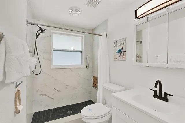 a bathroom with a sink toilet and shower