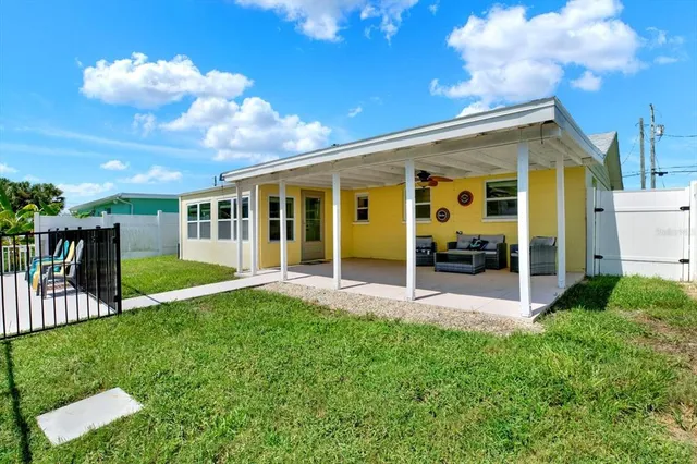 a view of a house with backyard and porch