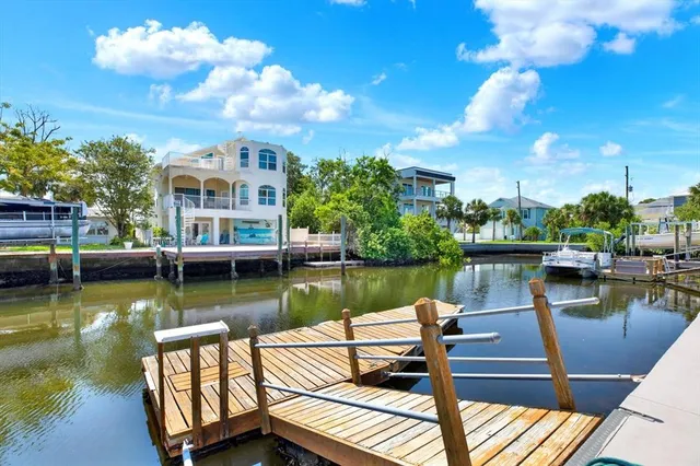 a view of a balcony with two couches and potted plants with sky view