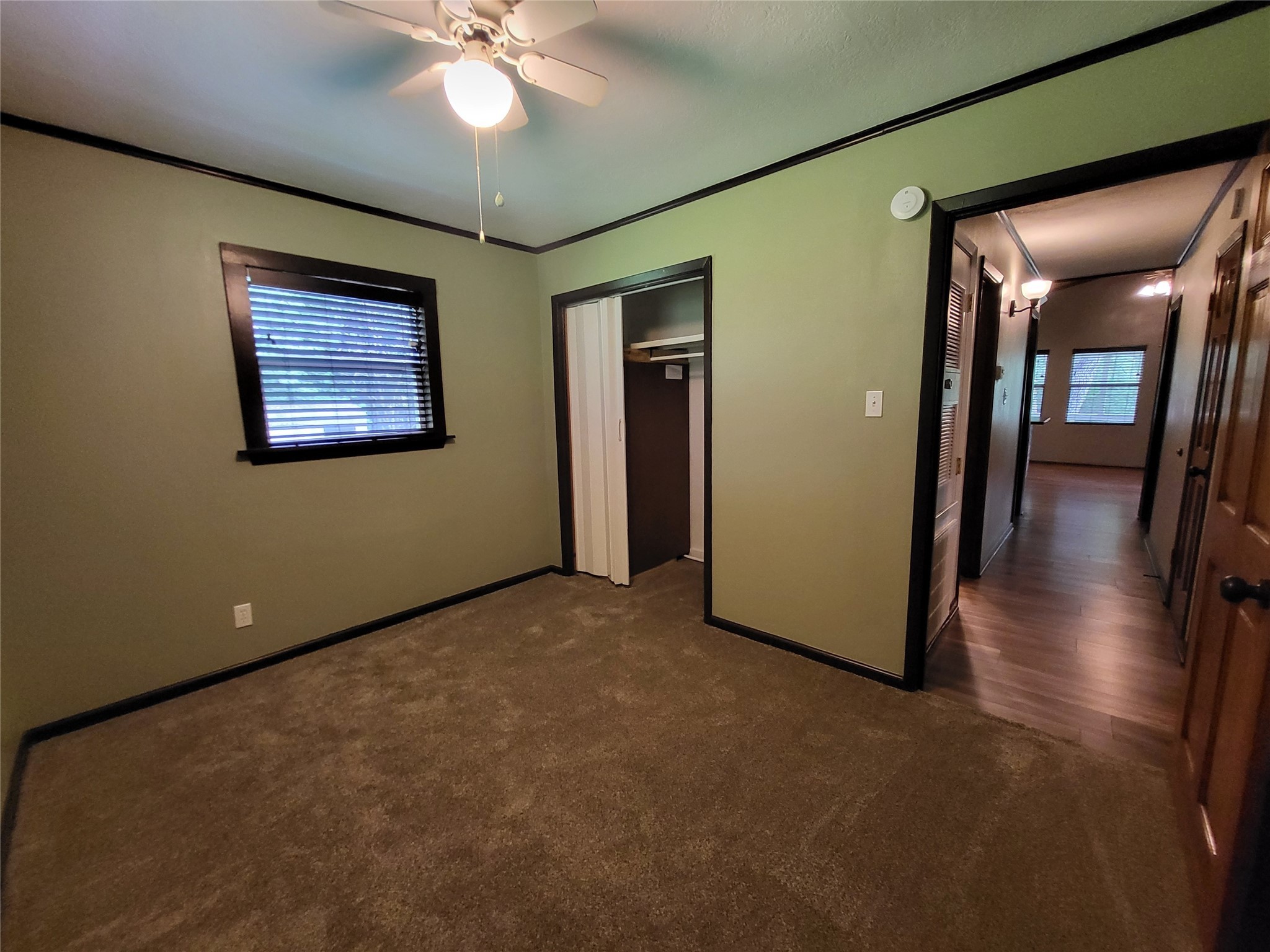 30 Ridge Creek Drive Coldspring, TX 77331 - Photo 12 of 38 a view of an empty room with window and wooden floor
