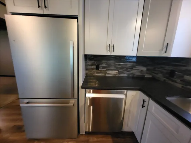 a close view of stove cabinets and refrigerator