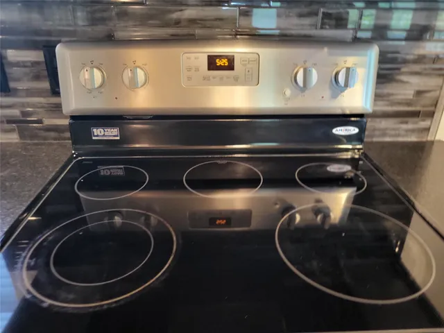 a stove top oven sitting inside of a kitchen