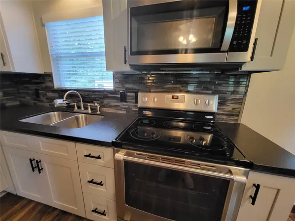 a kitchen with a stove and a microwave