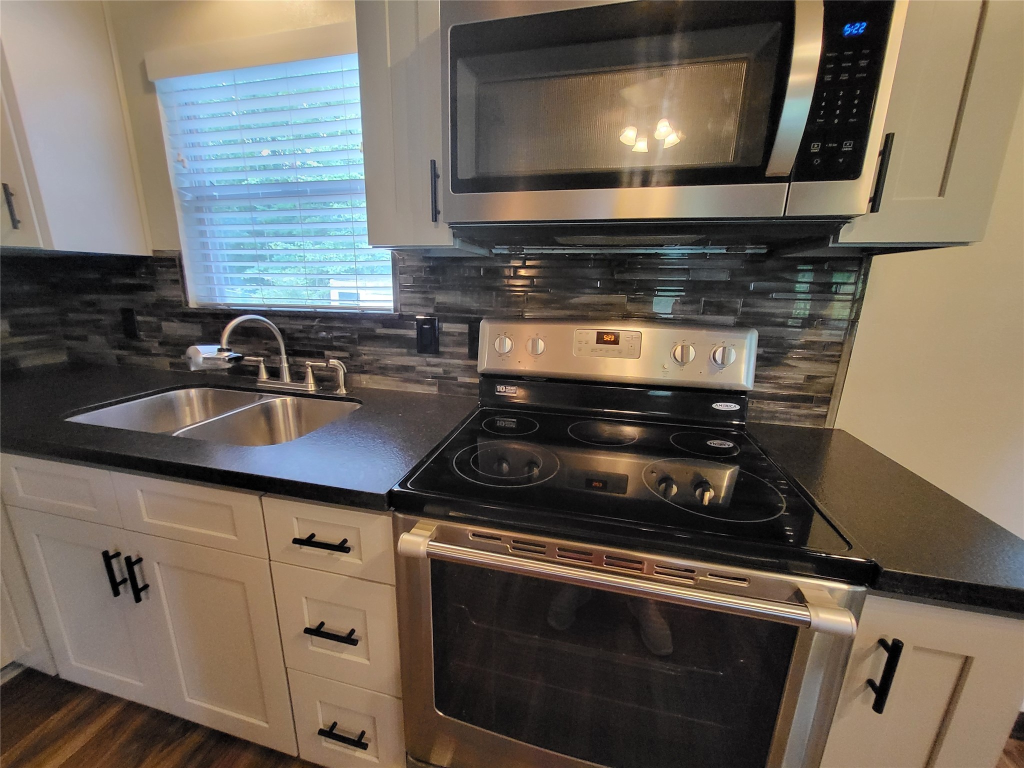 30 Ridge Creek Drive Coldspring, TX 77331 - Photo 19 of 38 a kitchen with a stove and a microwave