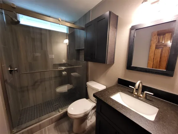 a bathroom with a sink toilet and shower