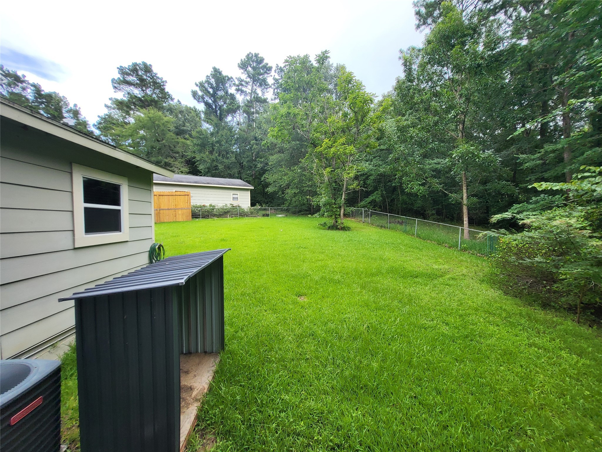 30 Ridge Creek Drive Coldspring, TX 77331 - Photo 29 of 38 a backyard of a house with lots of green space