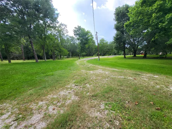 a view of field with trees in the background