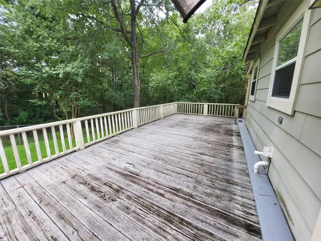 a view of balcony with wooden floor and fence