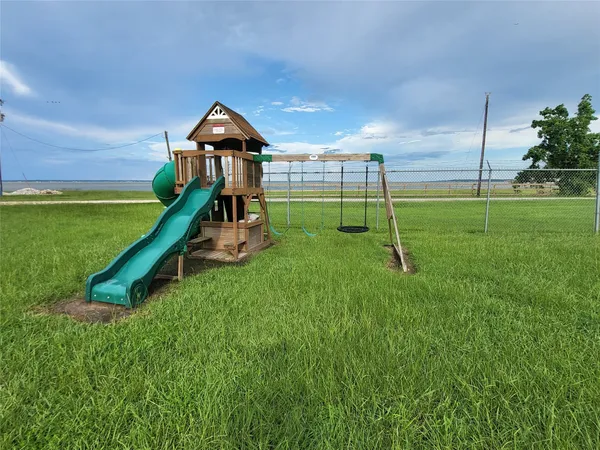 a swimming pool with lots of tress in front of it